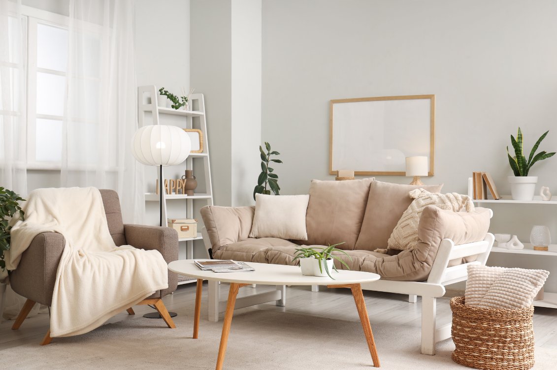 Cosy living room with a beige sofa, armchair and houseplants, creating a calm, welcoming space